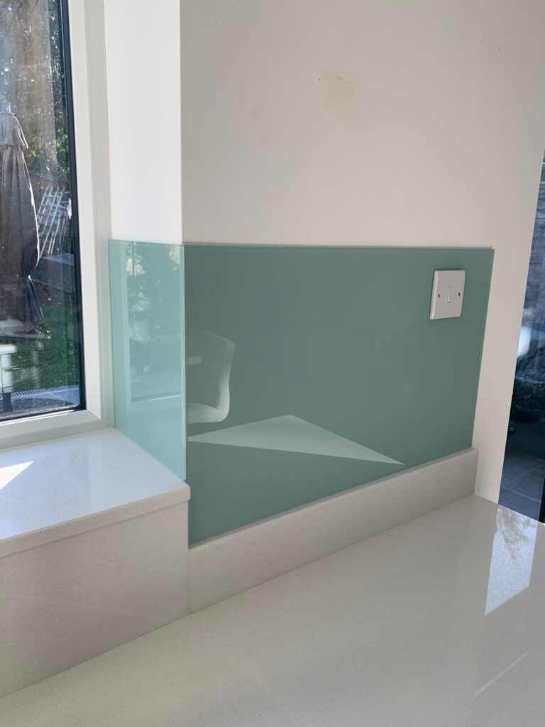 Frameless glass shower enclosure with hinged door and chrome hardware in a tiled bathroom