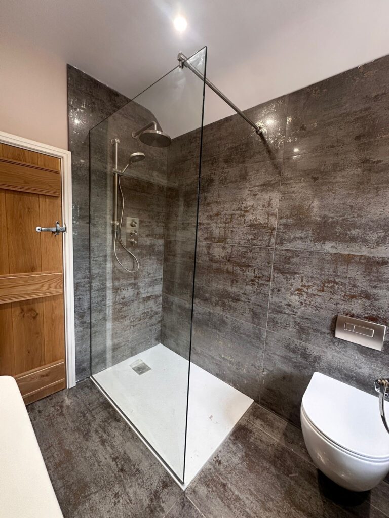 Minimal frameless glass shower screen in modern walk-in bathroom